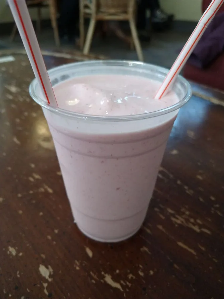 Pink strawberry milkshake with two straws